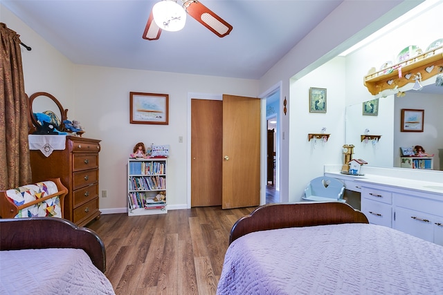 bedroom with ceiling fan and dark hardwood / wood-style flooring