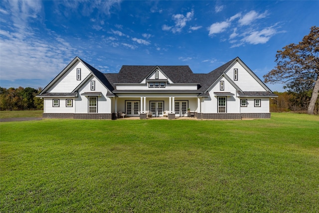 view of front of house featuring a front lawn and french doors