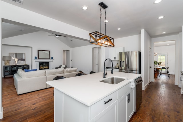 kitchen with pendant lighting, an island with sink, sink, white cabinets, and stainless steel appliances