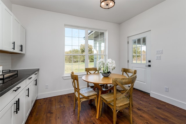 dining area with dark hardwood / wood-style flooring and a healthy amount of sunlight