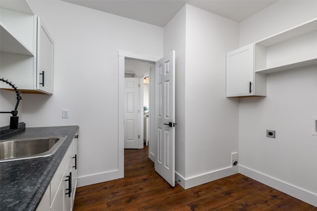 washroom with electric dryer hookup, dark hardwood / wood-style floors, and sink