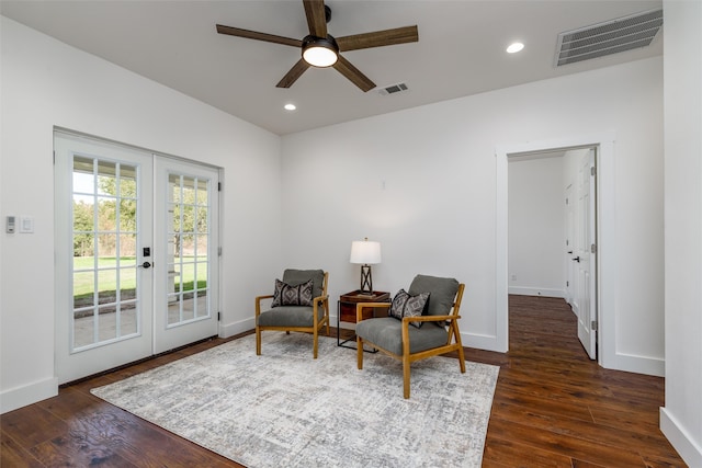 sitting room with dark wood-type flooring, ceiling fan, and french doors