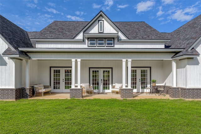 rear view of house featuring french doors and a yard