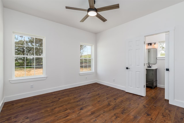 unfurnished bedroom featuring dark hardwood / wood-style floors, sink, and ceiling fan