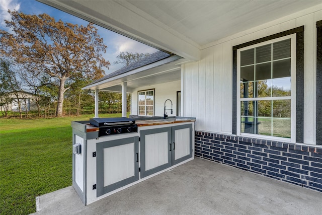 view of patio / terrace featuring a grill, exterior kitchen, and sink