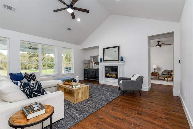 living room featuring ceiling fan, dark hardwood / wood-style flooring, and high vaulted ceiling