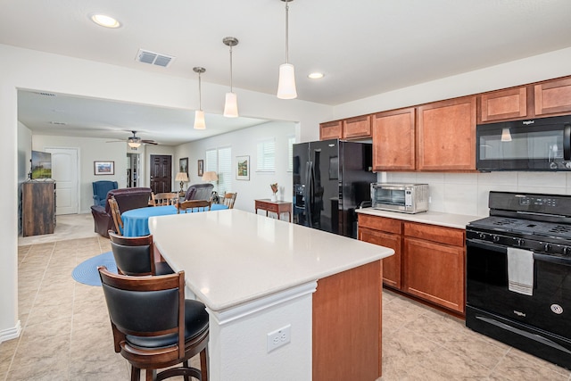 kitchen with a kitchen island, pendant lighting, black appliances, tasteful backsplash, and ceiling fan