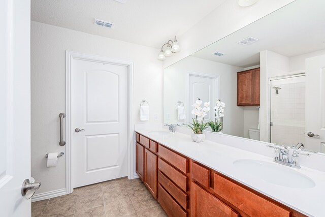 816 Hidden Eddy Dr, Mckinney, TX 75071 - full bathroom with double vanity, a shower with door, toilet, baseboards, and tile patterned flooring