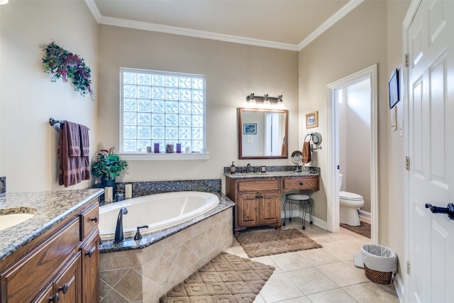 bathroom featuring tile patterned floors, toilet, a relaxing tiled tub, and vanity