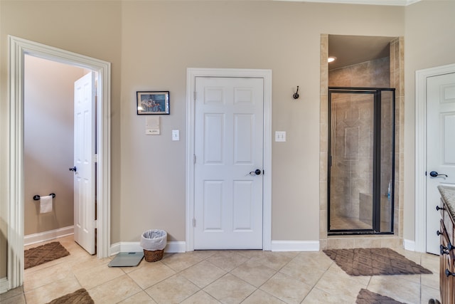 bathroom featuring vanity, tile patterned floors, and a shower with door