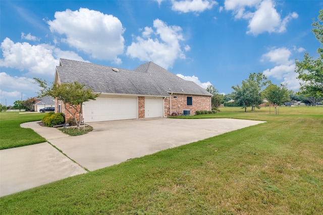 view of side of home featuring a garage and a lawn