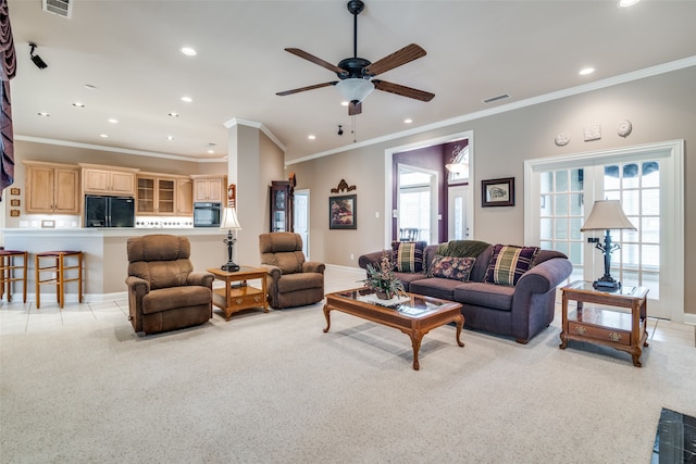 living room featuring ceiling fan and crown molding