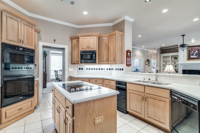 kitchen with black appliances, tasteful backsplash, a center island, sink, and ceiling fan