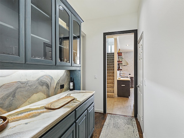 bathroom with vanity, wood-type flooring, and tasteful backsplash