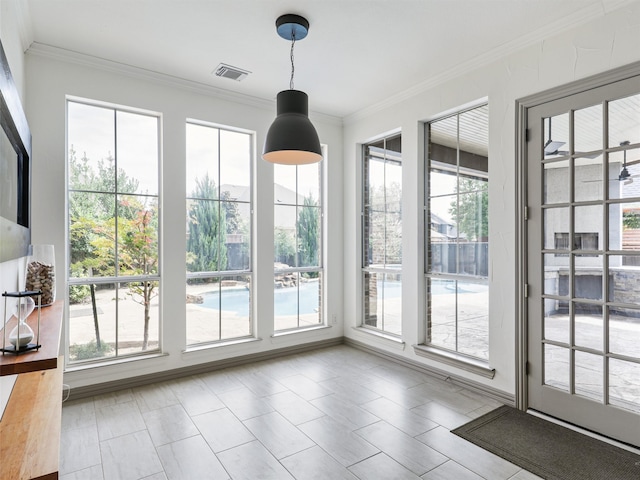 entryway with crown molding and a healthy amount of sunlight