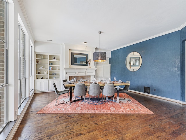 dining space featuring built in shelves, dark hardwood / wood-style flooring, and ornamental molding