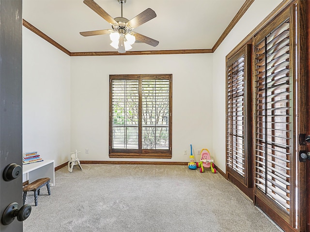 interior space featuring carpet, ceiling fan, and ornamental molding