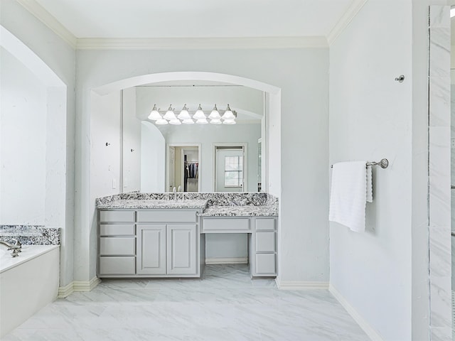 bathroom with vanity, ornamental molding, and a bathtub