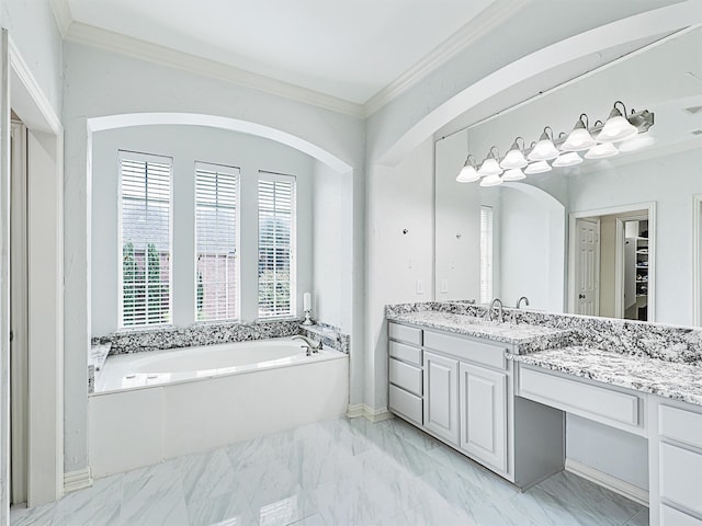 bathroom featuring crown molding, vanity, and a tub