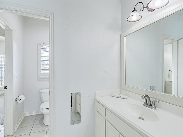 bathroom with vanity, toilet, and tile patterned flooring