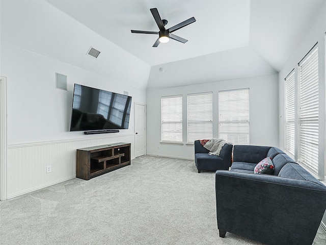 carpeted living room with a healthy amount of sunlight, ceiling fan, and vaulted ceiling