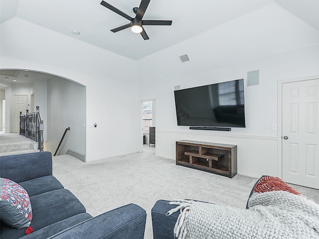 living room featuring lofted ceiling, ceiling fan, and carpet flooring