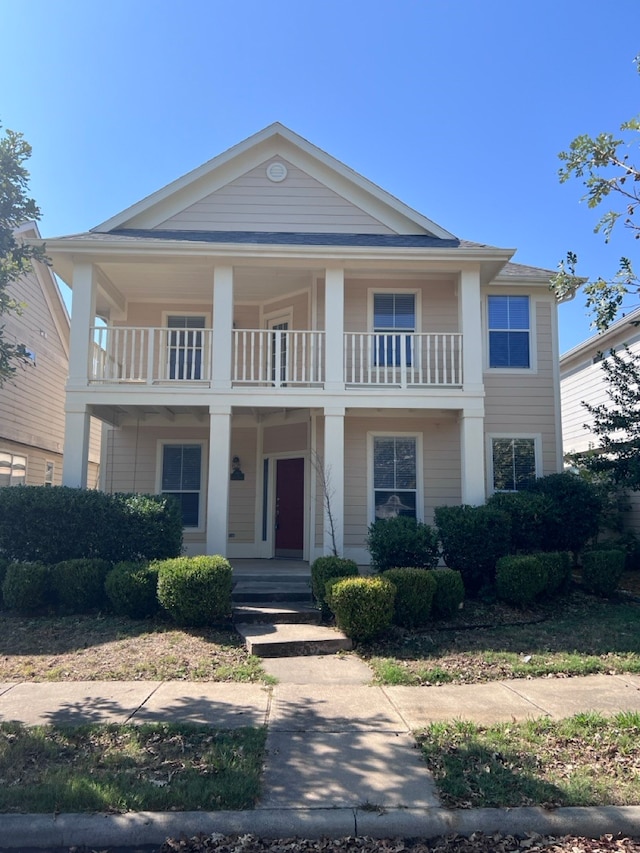 greek revival house with a balcony