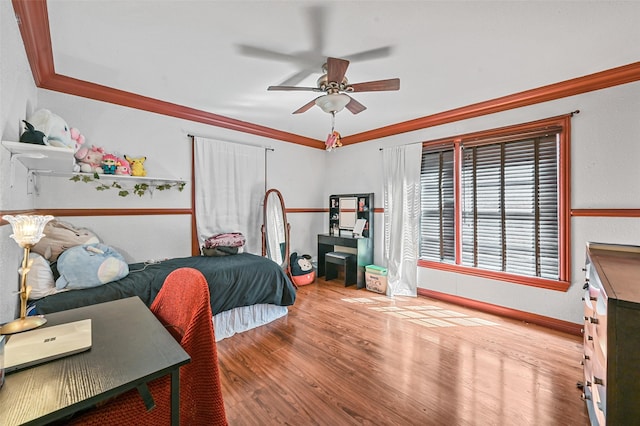 bedroom with ceiling fan, crown molding, and light hardwood / wood-style flooring