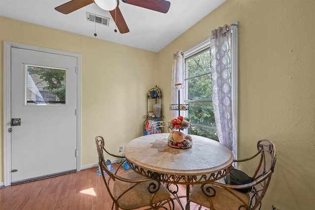 dining space with light wood-type flooring and ceiling fan