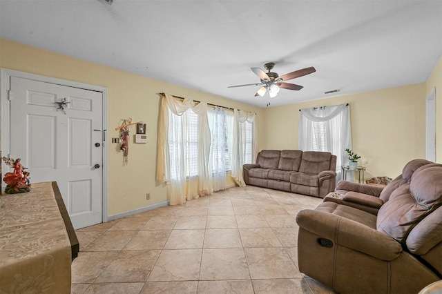 tiled living room featuring ceiling fan