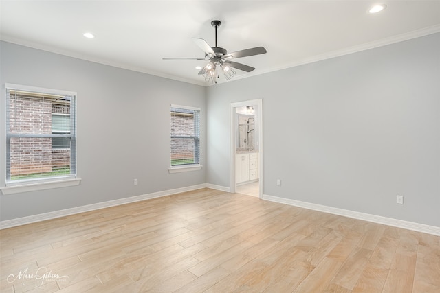 spare room with crown molding, ceiling fan, and light wood-type flooring