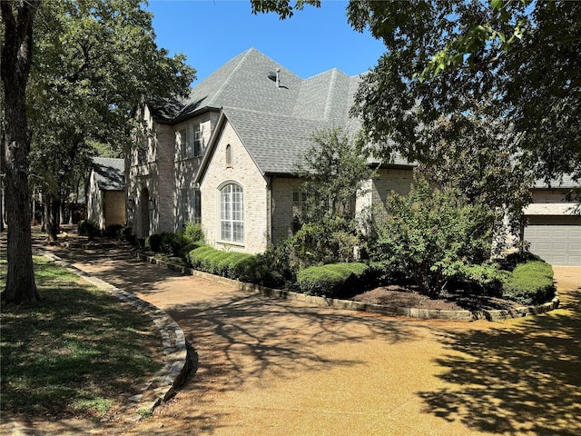 view of side of property with a lawn and a garage