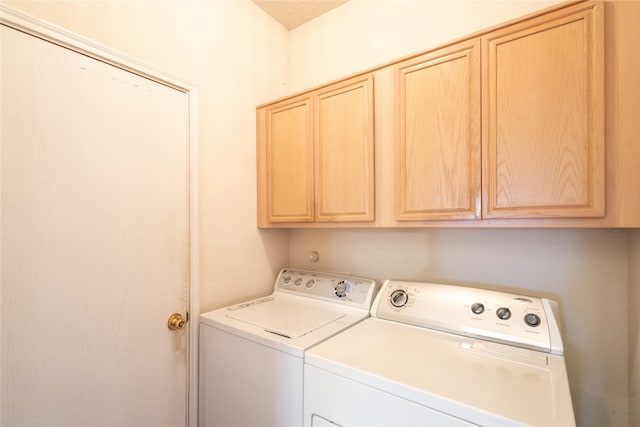 laundry area with cabinets and washer and dryer