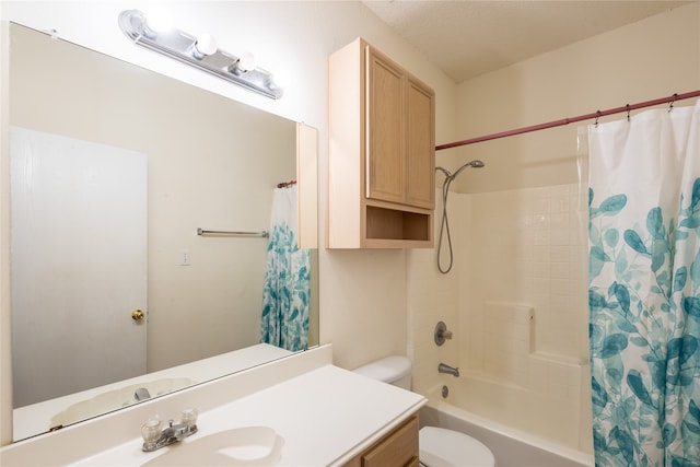 full bathroom with shower / bath combo, toilet, a textured ceiling, and vanity