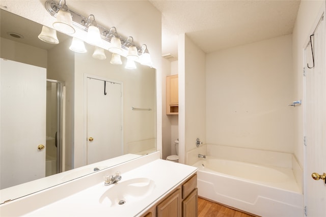 full bathroom featuring hardwood / wood-style floors, separate shower and tub, toilet, and vanity