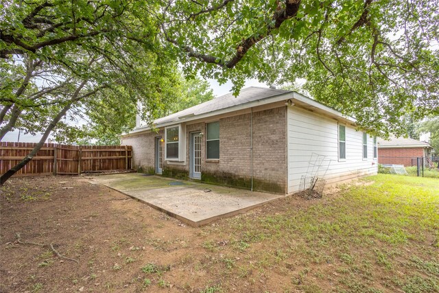 back of house featuring a yard and a patio