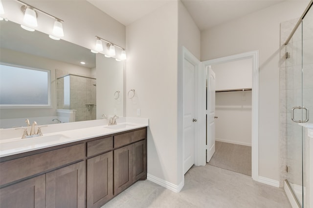 bathroom featuring walk in shower, tile patterned flooring, and vanity