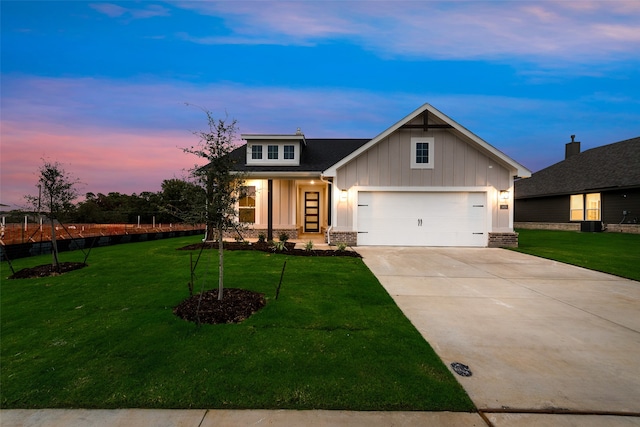 craftsman inspired home with a garage and a yard