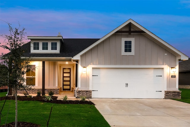 view of front facade with a garage and a yard