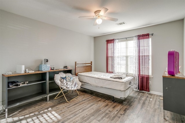 bedroom featuring ceiling fan and dark hardwood / wood-style floors