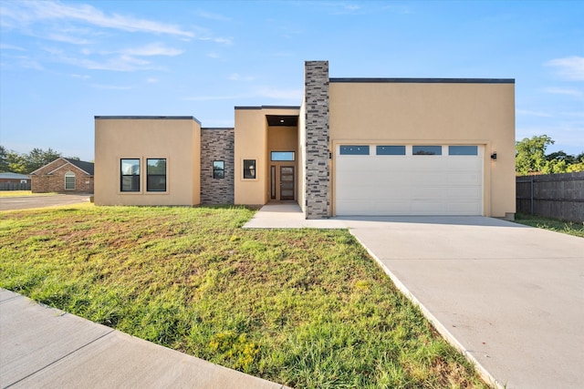 view of front of property featuring a garage and a front yard