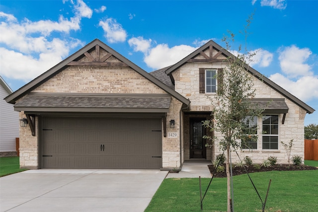 view of front of house with a front lawn and a garage