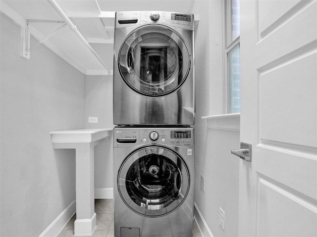 washroom featuring light tile patterned floors and stacked washer / drying machine