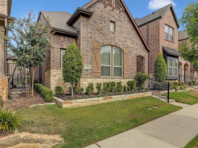 tudor home with a front yard