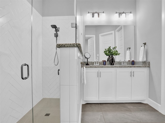 bathroom with vanity, tile patterned floors, and a shower with door