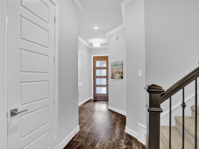 entrance foyer with crown molding and dark wood-type flooring