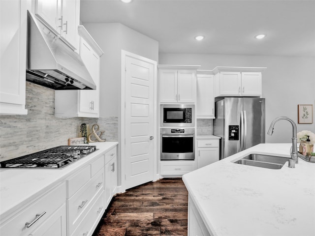 kitchen featuring tasteful backsplash, stainless steel appliances, sink, white cabinets, and dark hardwood / wood-style floors