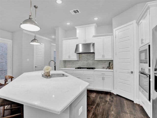 kitchen featuring stainless steel oven, sink, an island with sink, white cabinetry, and extractor fan