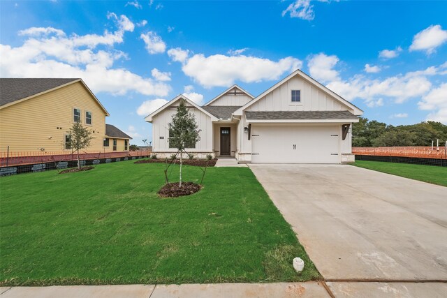 view of front facade with a garage and a front yard