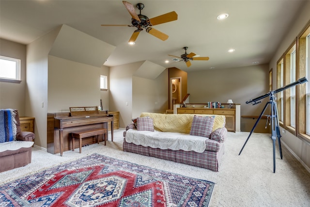 carpeted living room featuring vaulted ceiling and ceiling fan